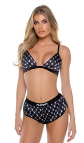 Satin bralette features Playboy bunny logo diamond screen print, triangle cups with plunge neckline, adjustable shoulder straps and swan hook back closure. Matching mini shorts features Playboy logo elastic and side slit openings. Two piece set.