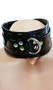 Vinyl choker with nail head studs and D Ring detail. Back has adjustable buckle closure.