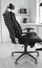 Side view of the RFM Verte 2200 Executive Chair in black leather showing the articulating back segments, adjustable headrest, ergonomic seat, and five-star base.