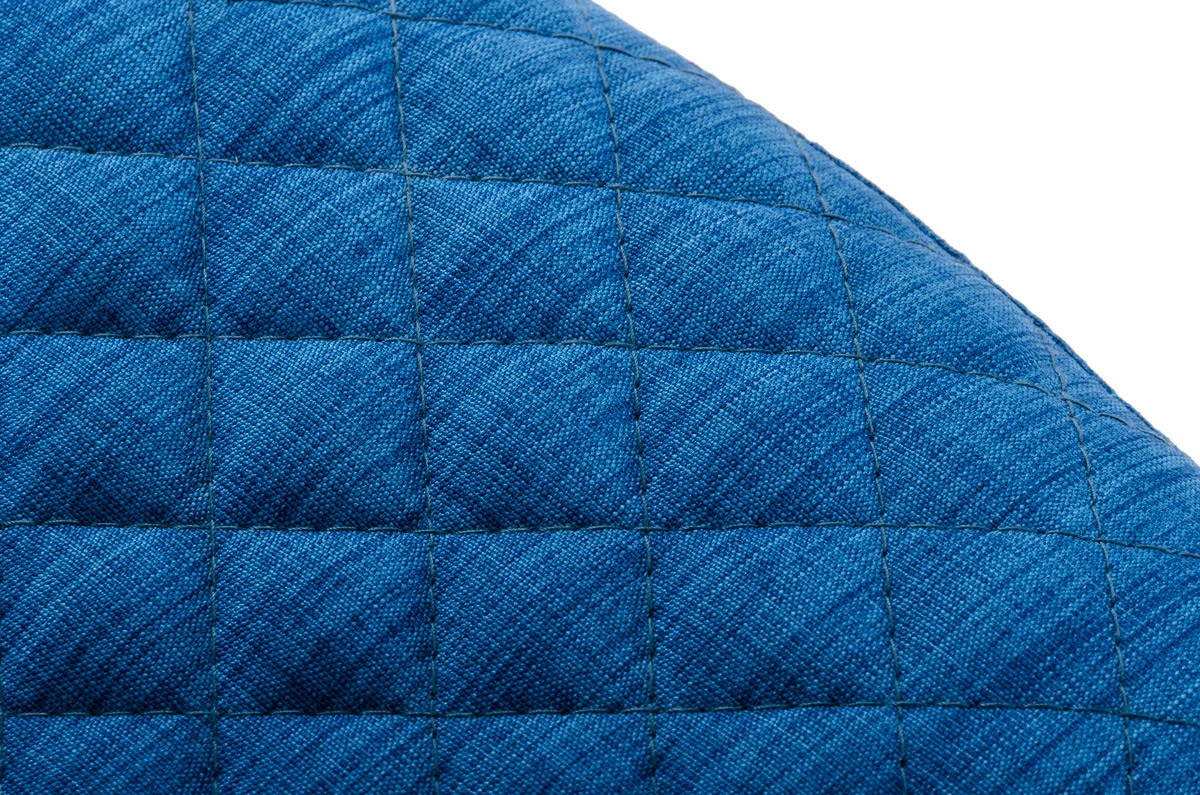 This is a close up shot of the blue fabric armchair