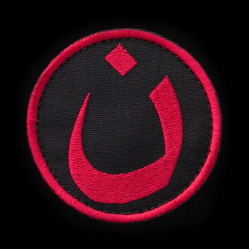 Nün patch, black background, red embroidery
