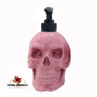 Bright pink skull soap dispenser with black pump unit.