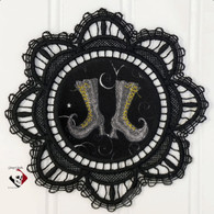 Black doily with pair of witch boots fabric inset.