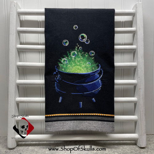 Cauldron embroidery design on black woven towel, Halloween decor.