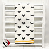 Bat print dish towel with trim.