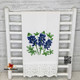 White cotton towel with lace trim on hem withTexas Bluebonnet embroidery design.
