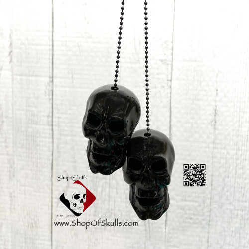 Black skulls rear view car charm.