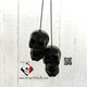 Black skulls rear view car charm.
