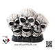 Three skulls in black antique on solid black rock base napkin holder or letter rack.
