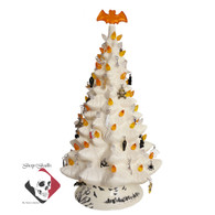 Halloween Tree with orange bat topper.  Halloween theme tree with candy corn color lights in orange, yellow and clear, topped with a bat topper, decorated with small spiders, cobwebs, cats, pumpkins, cauldrons, witch hats and brooms and many more.