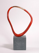 The bronze part has a natural bronze section fand is flanked by a red acrylic painted profile which freely rotates on the Cumbrian slate base. This allows the collector to choose any number of views as the piece is asymmetrical.
