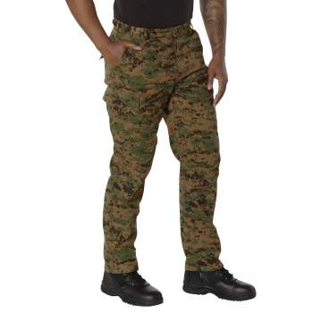 Experience over 4 decades of trusted design with our Digital Camo Tactical BDU Pants. Constructed from a robust cotton / polyester fabric blend, these military cargo pants are built for unparalleled performance and comfort. Providing flexibility, strength, and plenty of pockets, these BDUs are not afraid to get down and dirty, standing up to tough challenges during field missions, tactical operations, law enforcement duties, and outdoor adventures. Tried-and-True Reliability: These tactical military uniform pants are reinforced in the seat and knees for maximum durability that endures wear and tear while supporting a full range of motion. The wear-resistant double-stitched seams provide extra strength and years of reliable use as you train, ruck, sprint, hike, and climb. High-Capacity Cargo Pockets: The camouflage EDC cargo pants provide functional utility through a spacious 6 pocket design that consists of 2 large button-down cargo pockets, 2 front slash pockets, and 2 button-down back pockets for storing tactical gear or everyday essentials like your phone, wallet, keys, or multi-tool. Utility at the Forefront: These tactical camo hiking pants feature adjustable waist tabs that enable the perfect fit. In addition, the straight leg opening fits over boots comfortably while the drawstring ankle ties allow you to easily adjust the fit. These military BDU cargo pants utilize a button closure and fly. Action Ready: Initially designed for military personnel and tactical professionals, these adaptable and reliable tactical cargo pants are great for backpacking, camping, hiking, hunting, fishing, working, public safety, skateboarding, everyday wear, and more.