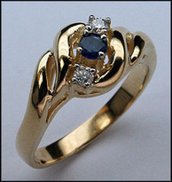 Gold Ring with a 5pt Sapphire Center and 2 Diamonds