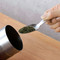 A scene of scooping tea leaves with a tea scoop (tea spoon)