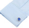 blue speedometer cufflinks displayed on a white dress shirt sleeve cuff