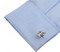 silver elephant cufflinks displayed on a white dress shirt sleeve cuff close up image