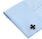 black iron cross cufflinks displayed on a white shirt sleeve cuff close up image