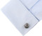 silver owl head cufflinks displayed on a white dress shirt sleeve cuff close up
