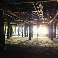 Sun through Poles on Sand