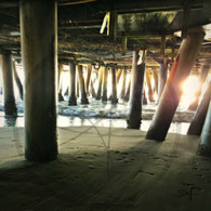 Wave Coming to Shore Through Poles