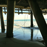 Wave Crash on Pier Poles