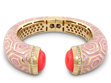 This designer bangle has pink coral stones at each end and is beautifully pink enameled and opens by a hinge. This fashion bangle is comfortable to wear. Arrives packaged in a pouch.
