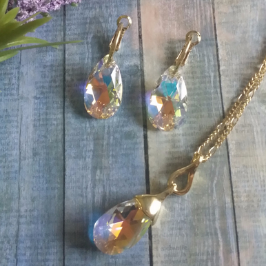 Beautiful Aurora Borealis crystal stone necklace set with matching Aurora Borealis crystal earrings. Available in posts only with leverbacks for a secure and comfortable fit. Necklace is 18" in length, gold and rhodium plating with lobster clasp. Arrives beautifully packaged. Ships with tracking, Arrives 2 to 3 days.