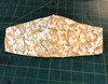 Summer Weight Cotton Fabric in the "Elegance" Pattern in tan and white..like all masks, elastic around the head or over the ears