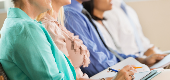 Group of adult students, taking notes in a workshop