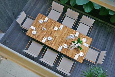 NATUN Slat Table 88.5" x 39.5" (teak) with NATUN Stacking Chairs (hemp)
