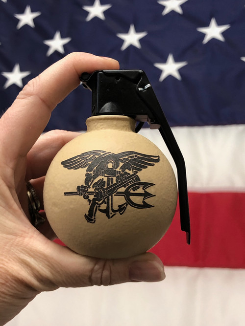- Made in the USA
- Steel Casting with a Sheet Metal Spoon; uniquely different not perfectly symmetrical
- Noticeable imperfections, dents, divots and elevated ridges
- Desert Sand Color with Trident on one side and Navy SEAL Museum Shooter Logo on the other

- Comes in a splendid wooden gift box

- Do NOT take this into the airport

This frag grenade bottle opener will open all of your bottles and have your friends asking if they can try it and then where they can buy

Made by Bottle Breacher A Veteran Owned and Operated businesses started by Former Navy SEAL, Eli Crane, and his wife Jen who brought it to Shark Tank

 