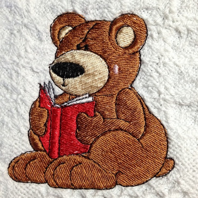 Embroidered on white cotton with red book.