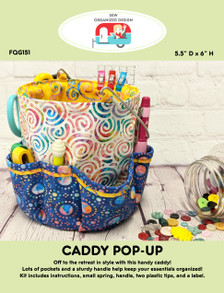 The Caddy Pop Up is a fun container with a spring inside. Lots of pockets and a sturdy stainless steel handle help keep your essentials organized.   Image shows retail packaging of one caddy pop up.