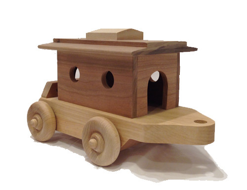 What train would be complete without a caboose to carry the passengers? Ours arrives with two little people looking out the windows. The roof is easily removed so the people can get in and out. The caboose is 10" long x 4" wide. 