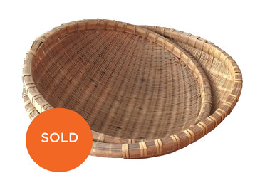 Pair of round handwoven baskets, circa 1960s