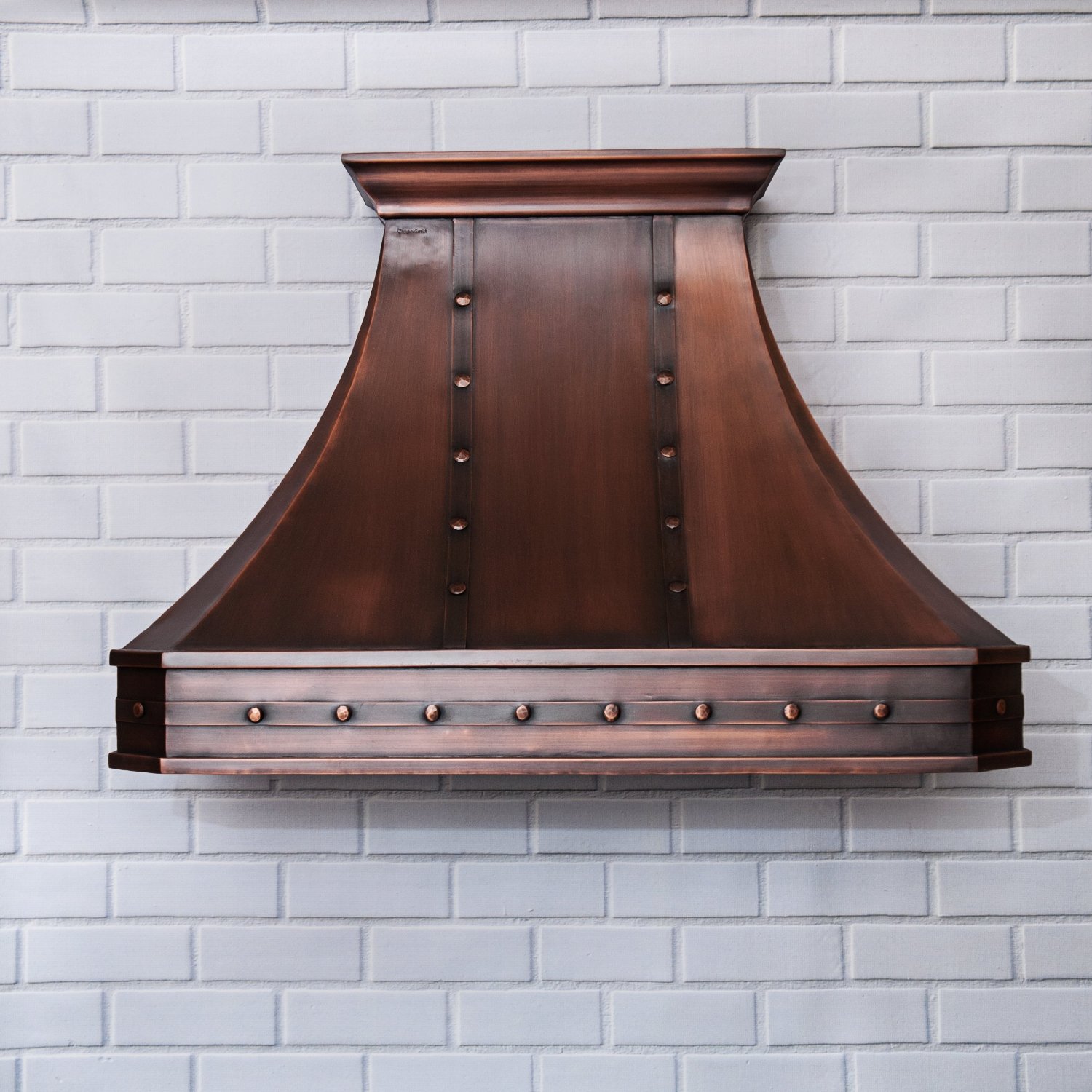 hand hammered copper vent hood with straps in a kitchen