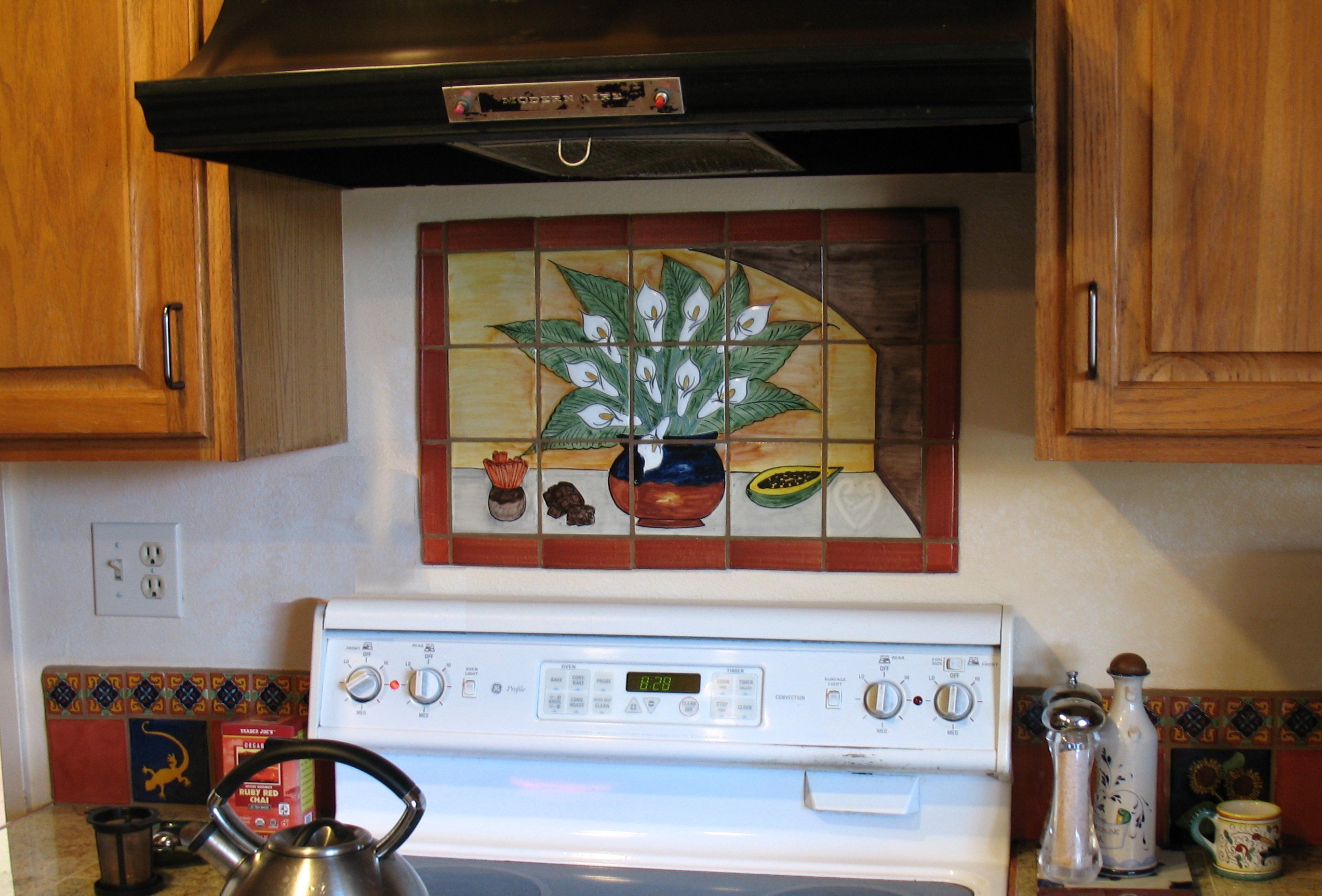 hand painted ceramic tile mural from Mexico decorating a kitchen backsplash wall