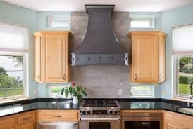 hammered copper range hood installed on a kitchen wall