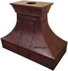 Side view of handcrafted slopping shape copper range hood.