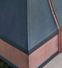 dark zinc range hood detail showing hammered copper apron