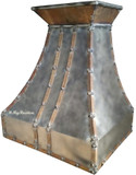 Front view of the Michigan Iron Range Hood showcasing its rusted crown, decorative straps, and raw iron body for a rustic-industrial look.