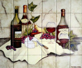 Hand-painted tile mural showcasing an elegant wine-and-cheese still life scene, with bottles, grapes, cheese, and a rustic yet refined ambiance.