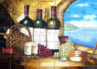 Hand-painted ceramic mural depicting a sophisticated still life of bread, wine, cheese, and grapes, framed by an arched window overlooking a coastal landscape.