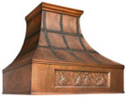 Luxury copper range hood with an antique patina finish for a high-end kitchen