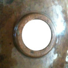 back view of a traditional bathroom sink made of hammered copper