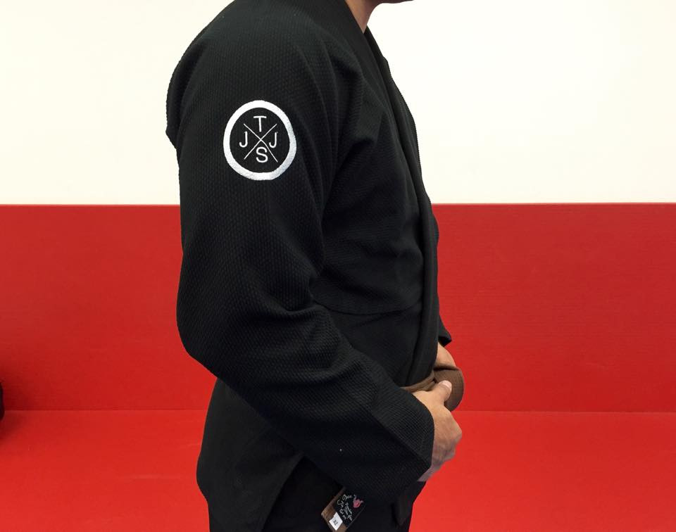 Side patch of the Kimono. TJJS Minimalist Kimono Black with a white patch.  Available at www.thejiujitsushop.com.  The Minimalist Gi is a perfect mix between comfort durability and affordability.  Simple gi.

Enjoy Free Shipping from The Jiu Jitsu Shop today!