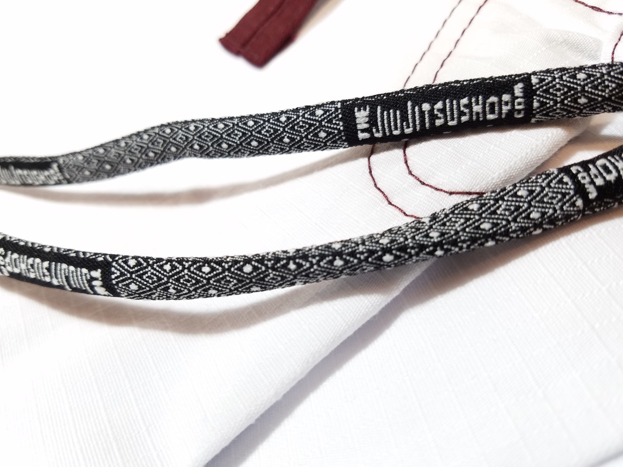 Drawstrings for the minimalist gi.  White with burgandy