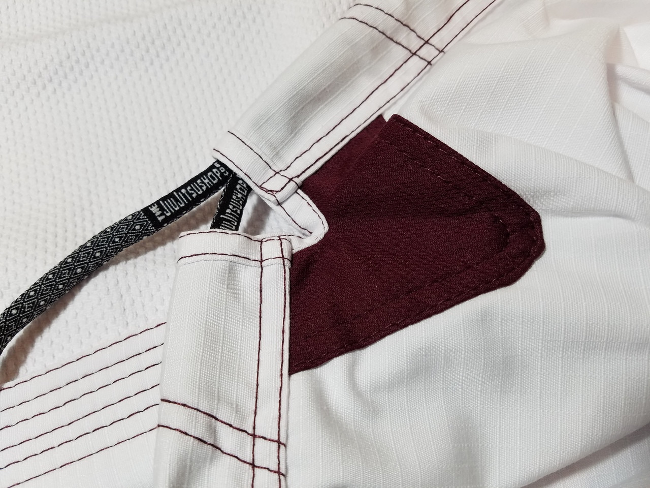 The Jiu Jitsu Shop Minimalist White with Burgandy accents.  Specifically cut for women.  Available at www.thejiujitsushop.com

Enjoy Free Shipping today! 