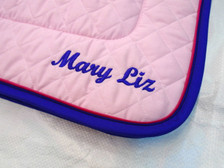 Pink Embroidered Saddle Pad with Purple Trim and Raspberry Piping Close Up