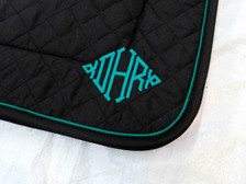 Black Embroidered Saddle Pad with Black Trim and Teal Piping Close Up